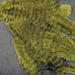 A close-up of Hareline Grizzly Marabou feathers in Olive #263, highlighting the deep olive-green fibers paired with contrasting dark barred grizzly markings.