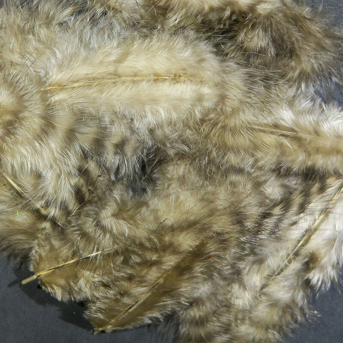 A close-up of Hareline Grizzly Marabou feathers in Tan #369, showcasing soft, sandy tan fibers detailed with light brown and cream barred grizzly variegation.