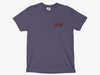 Front view of the grape purple Yakoda Drippy Trout Short Sleeve Tee showing the small neon retro chest logo.