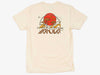 Flat view of the ivory Yakoda Prairie Tee showcasing the western sunrise, cottonwood, and fly fishing back graphic.