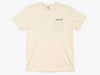 Front view of the ivory Yakoda Prairie Short Sleeve Tee showing the functional left chest pocket and logo print.